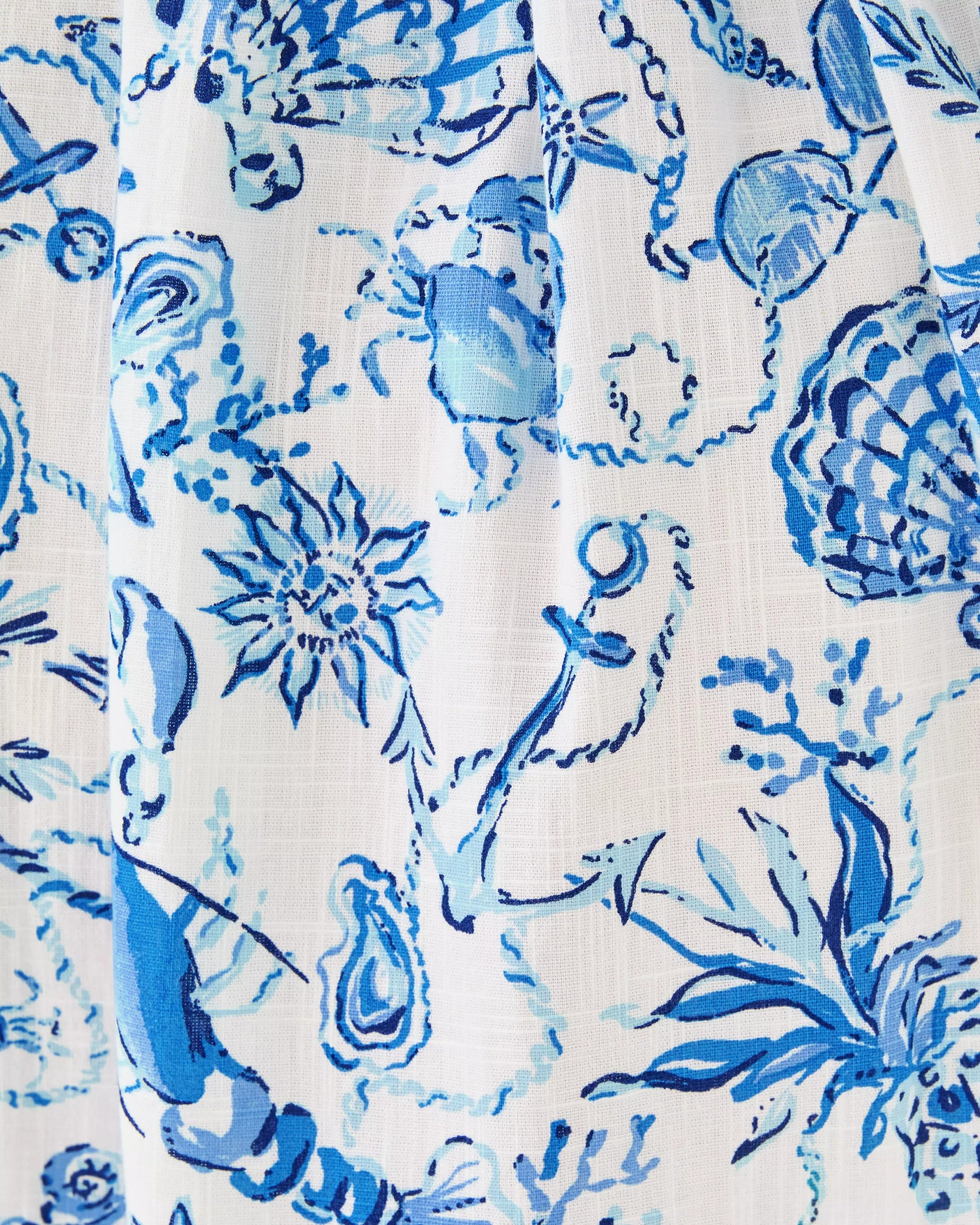 Close-up of a blue floral pattern on a white background