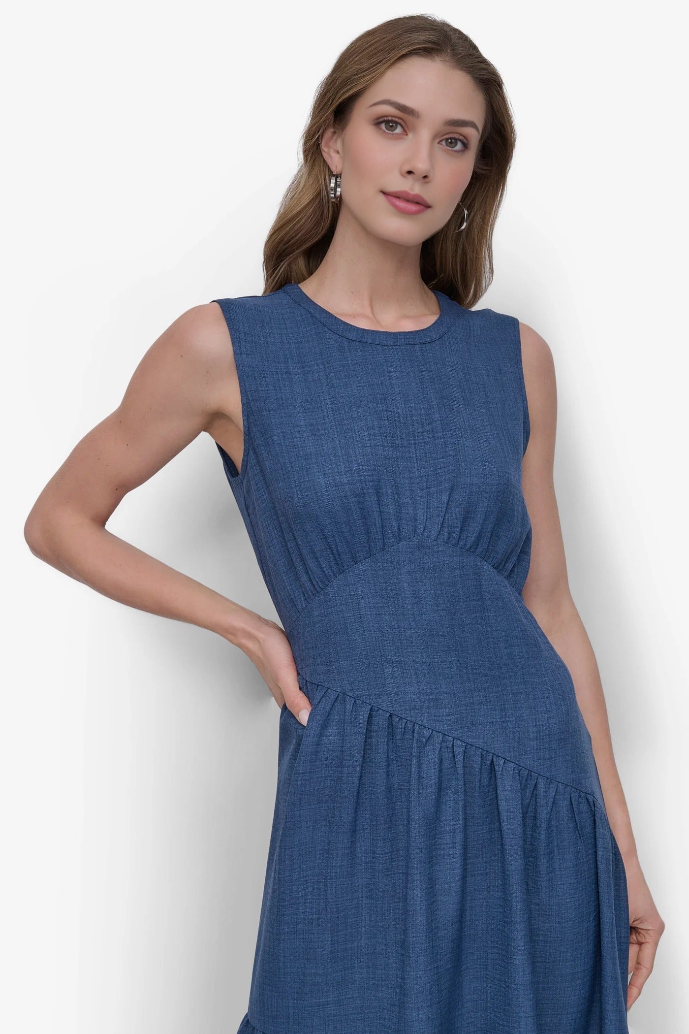 Woman wearing a blue dress against a white background, blue denim dress, midi, western dress, european fashion, summer party dress