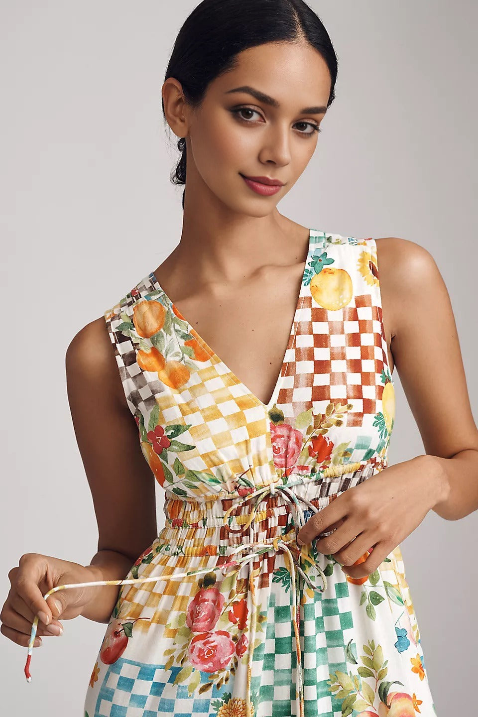 Woman wearing a colorful patterned dress against a plain background. summer vibe dress. beach dress