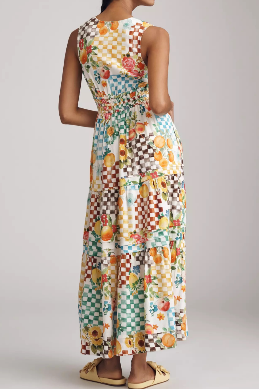 Woman wearing a colorful patterned dress on a plain background. fruity summer design