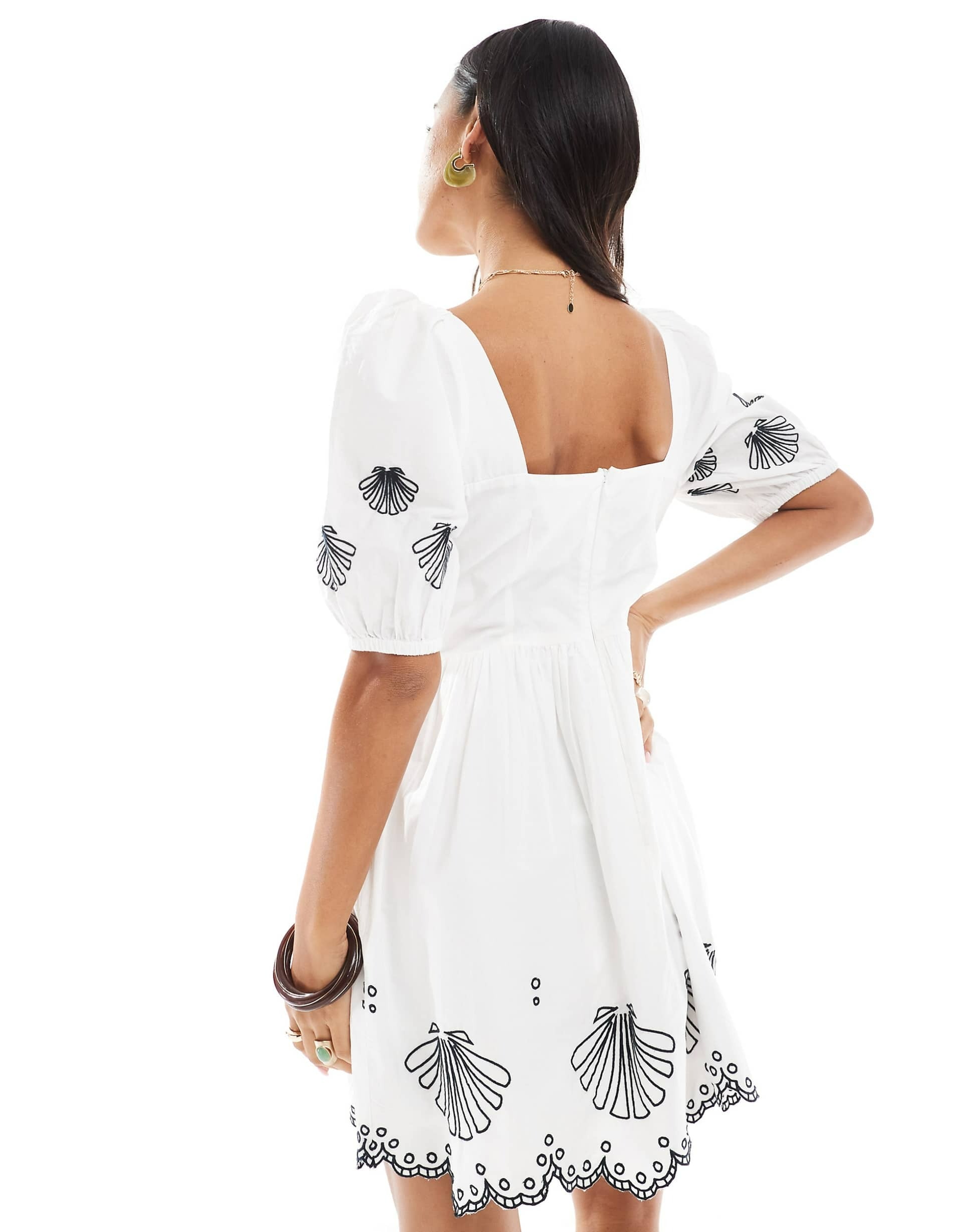 White dress with black embroidery on a white background. western style
